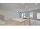 Open-concept living room with island, ceiling fan and natural light at 504 Amethyst Way, Stockbridge, GA 30281