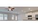 Open-concept living room with recessed lights connects to the kitchen and dining area, perfect for entertaining at 504 Amethyst Way, Stockbridge, GA 30281