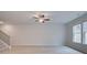 Bright living room featuring a ceiling fan and large windows at 504 Amethyst Way, Stockbridge, GA 30281