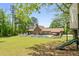 Expansive backyard with a pool, covered patio, and mature trees, ideal for outdoor activities and relaxation at 3222 Bay View Dr, Jonesboro, GA 30236