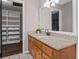 Bathroom vanity with granite countertop, adjacent to closet with shelving and drawers at 3222 Bay View Dr, Jonesboro, GA 30236