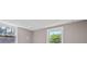 Bedroom with windows offering views of lush greenery and neutral paint at 3222 Bay View Dr, Jonesboro, GA 30236