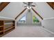 Bonus room features triangular windows, exposed beams, and built-in shelving at 3222 Bay View Dr, Jonesboro, GA 30236