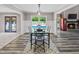 A dining room with wood flooring, a view of the pool through a glass door, and a fireplace in the adjacent room at 3222 Bay View Dr, Jonesboro, GA 30236