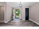 Inviting entryway with hardwood floors, a stylish light fixture, and an open door leading to the outdoors at 3222 Bay View Dr, Jonesboro, GA 30236