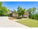 Charming exterior showcasing a well-maintained home with a driveway, attached garage, and beautiful landscaping at 3222 Bay View Dr, Jonesboro, GA 30236