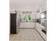 Well-lit kitchen with white cabinets, stainless steel appliances, and tiled floors at 3222 Bay View Dr, Jonesboro, GA 30236