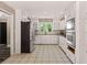 Well-lit kitchen with white cabinets, stainless steel appliances, and tiled floors at 3222 Bay View Dr, Jonesboro, GA 30236