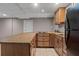 Basement kitchen with tiled floors, ample counter space, wood cabinetry, and stainless appliances at 3222 Bay View Dr, Jonesboro, GA 30236