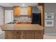 Basement kitchenette featuring a breakfast bar, stove, microwave, and refrigerator at 3222 Bay View Dr, Jonesboro, GA 30236