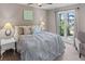 A primary bedroom with a ceiling fan and large windows that provide great lighting and view of the lake at 3222 Bay View Dr, Jonesboro, GA 30236