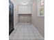 A mud room with overhead cabinet storage and tile flooring with a side facing window at 3222 Bay View Dr, Jonesboro, GA 30236