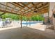 Covered patio featuring ceiling fan and ample space for lounging and entertaining by the pool at 3222 Bay View Dr, Jonesboro, GA 30236