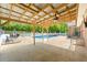 An outdoor patio with ceiling fan covering the seating area, in addition to the inground pool, and outdoor dining area at 3222 Bay View Dr, Jonesboro, GA 30236