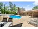 This home has an in-ground pool surrounded by lounge chairs for relaxing and soaking up the sun at 3222 Bay View Dr, Jonesboro, GA 30236
