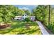 Spacious lot with beautiful landscaping and a long driveway leading up to the charming home at 3222 Bay View Dr, Jonesboro, GA 30236