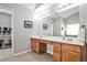 Bathroom with a double vanity, large mirror, and tile floor at 334 Pin Oak Ave, Woodstock, GA 30188