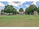 Expansive grassy lawn with a gazebo, framed by mature trees and neighborhood buildings at 334 Pin Oak Ave, Woodstock, GA 30188