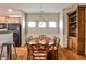 Traditional dining room with hardwood floors, wood table, floral chairs, and a wood china cabinet at 334 Pin Oak Ave, Woodstock, GA 30188