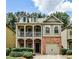 Charming two-story home boasts a brick facade, quaint balcony, and well-maintained landscaping at 334 Pin Oak Ave, Woodstock, GA 30188