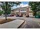 View of a two-story brick building with balconies, awnings, and parking at 334 Pin Oak Ave, Woodstock, GA 30188