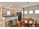 Open-concept kitchen and dining area with wood floors and dark countertops at 334 Pin Oak Ave, Woodstock, GA 30188
