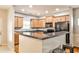 Well-lit kitchen featuring stainless steel appliances, a granite countertop and wooden cabinetry at 334 Pin Oak Ave, Woodstock, GA 30188