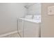 Laundry room features a white washer and dryer at 334 Pin Oak Ave, Woodstock, GA 30188