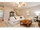 Cozy living room with a ceiling fan, hardwood floors, staircase, and comfortable furniture at 334 Pin Oak Ave, Woodstock, GA 30188