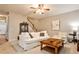Cozy living room with a ceiling fan, hardwood floors, staircase, and comfortable furniture at 334 Pin Oak Ave, Woodstock, GA 30188