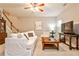 Bright living room with hardwood floors, staircase, and comfortable furniture at 334 Pin Oak Ave, Woodstock, GA 30188