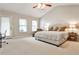 Bedroom features a ceiling fan, chair, desk, bedside table and carpet at 334 Pin Oak Ave, Woodstock, GA 30188