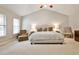 Bedroom features a ceiling fan, chair, bedside table and carpet at 334 Pin Oak Ave, Woodstock, GA 30188