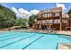 Community pool with lounge chairs provides a relaxing and luxurious experience at 334 Pin Oak Ave, Woodstock, GA 30188