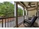 Relaxing porch with wicker furniture offers a serene outdoor living space overlooking lush trees at 334 Pin Oak Ave, Woodstock, GA 30188