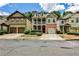 A row of suburban homes each with garages and driveways lining the street at 334 Pin Oak Ave, Woodstock, GA 30188