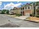A suburban street showcasing homes with garages, driveways, and manicured lawns on a sunny day at 334 Pin Oak Ave, Woodstock, GA 30188