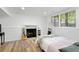 Finished basement featuring a cozy fireplace and bedroom area with vinyl flooring and natural light at 3512 Lynview W Ct, Decatur, GA 30034