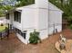 Exterior home featuring a clean white siding, outdoor fire pit, and elevated deck at 3512 Lynview W Ct, Decatur, GA 30034