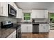 Modern kitchen featuring white cabinetry, stainless steel appliances, and granite countertops at 3512 Lynview W Ct, Decatur, GA 30034