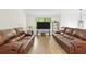 Bright living room features hardwood floors, a large window, and leather sofas at 3512 Lynview W Ct, Decatur, GA 30034