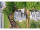 Aerial shot of the home, displaying its roof, backyard, landscaping, and neighborhood surroundings at 4092 Grand Park Dr, Suwanee, GA 30024