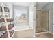 Bright bathroom featuring a soaking tub with shower and decorative towel rack at 4092 Grand Park Dr, Suwanee, GA 30024