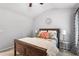 Bright bedroom featuring a wood-frame bed, neutral walls, and decorative pillows and lamps at 4092 Grand Park Dr, Suwanee, GA 30024