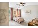 Charming bedroom with a ceiling fan, plush pink bedding, and decorative wall art at 4092 Grand Park Dr, Suwanee, GA 30024