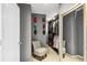 Well-appointed walk-in closet featuring custom shelving, ample storage, and a stylish accent chair at 4092 Grand Park Dr, Suwanee, GA 30024