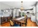 Stylish dining area featuring hardwood floors, neutral wall color, and decorative wall plates at 4092 Grand Park Dr, Suwanee, GA 30024