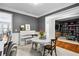 Open-concept dining area with a white table, stylish seating, and seamless transition to other living spaces at 4092 Grand Park Dr, Suwanee, GA 30024