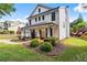 Charming two-story white home boasts a covered front porch, manicured landscaping, and inviting curb appeal at 4092 Grand Park Dr, Suwanee, GA 30024