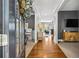 Inviting foyer with hardwood floors, views of the living spaces, and a decorative wreath on the front door at 4092 Grand Park Dr, Suwanee, GA 30024